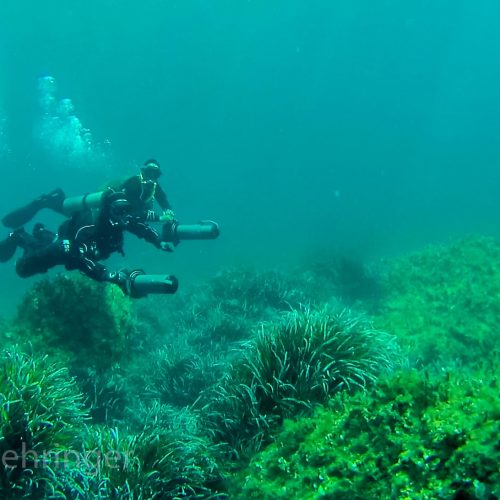 two sidemount scooter divers